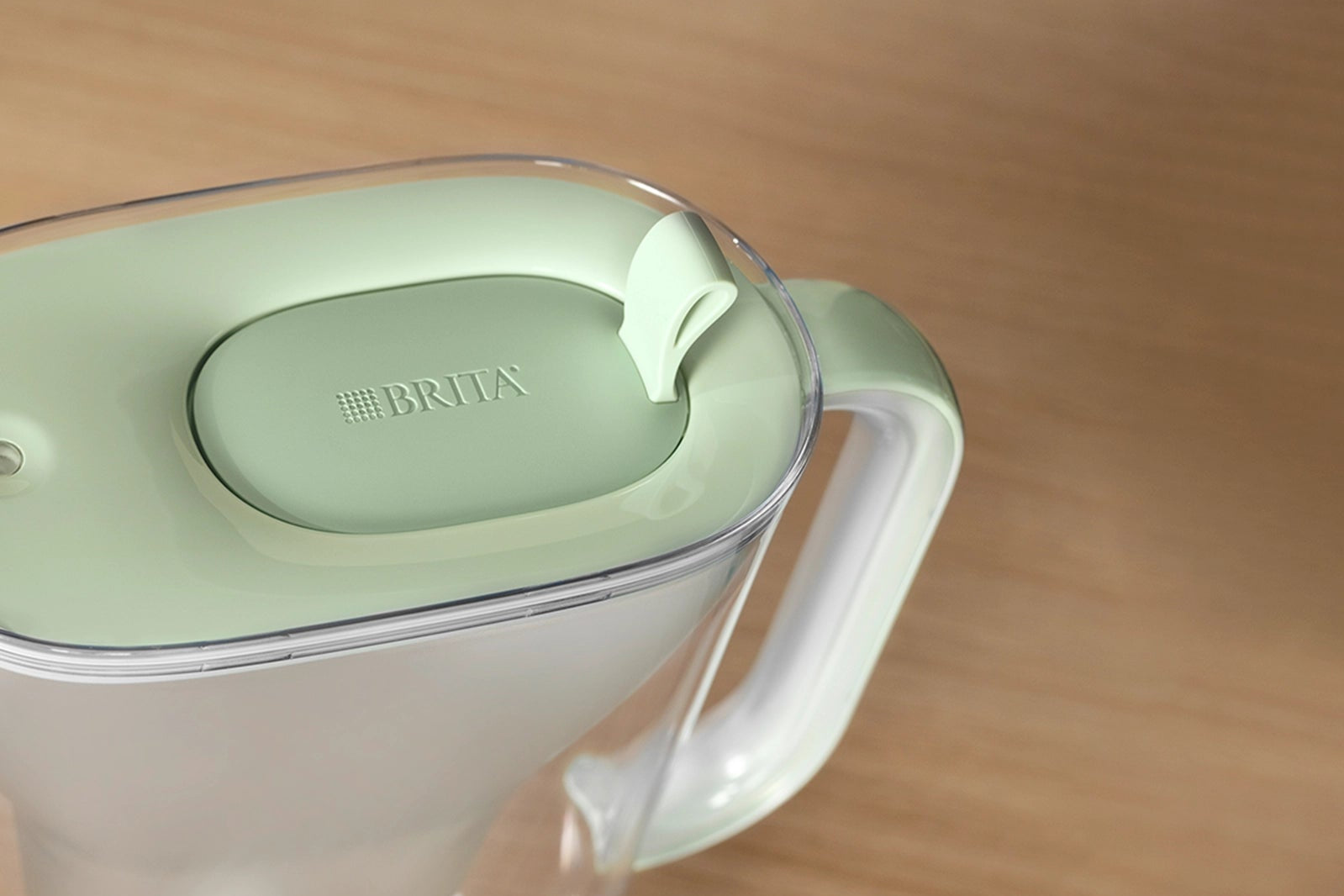 A BRITA Style eco water filter jug lid from above on a wooden surface.