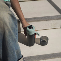 BRITA water filter bottle Model Active in green standing outside