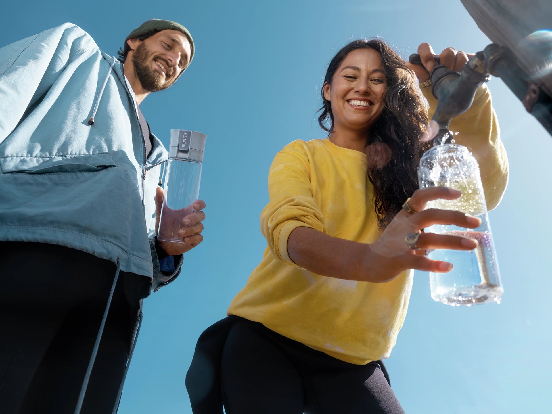 People filling BRITA water filter bottle Model Vital outdoor