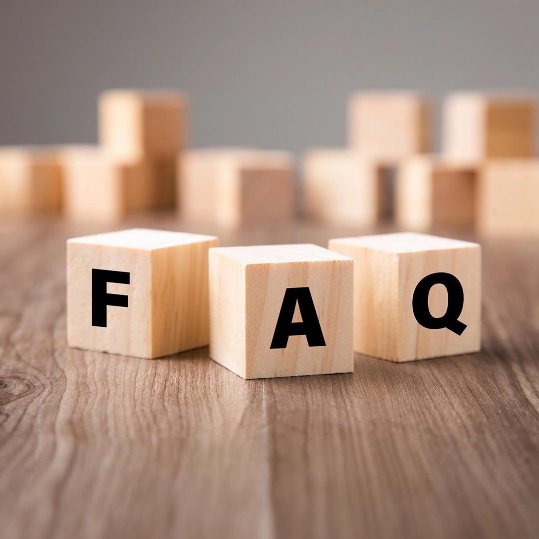 Wooden blocks with letters forming 'FAQ' on a wooden surface