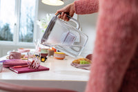 Person pouring water glass with BRITA Style Essential water filter jug.