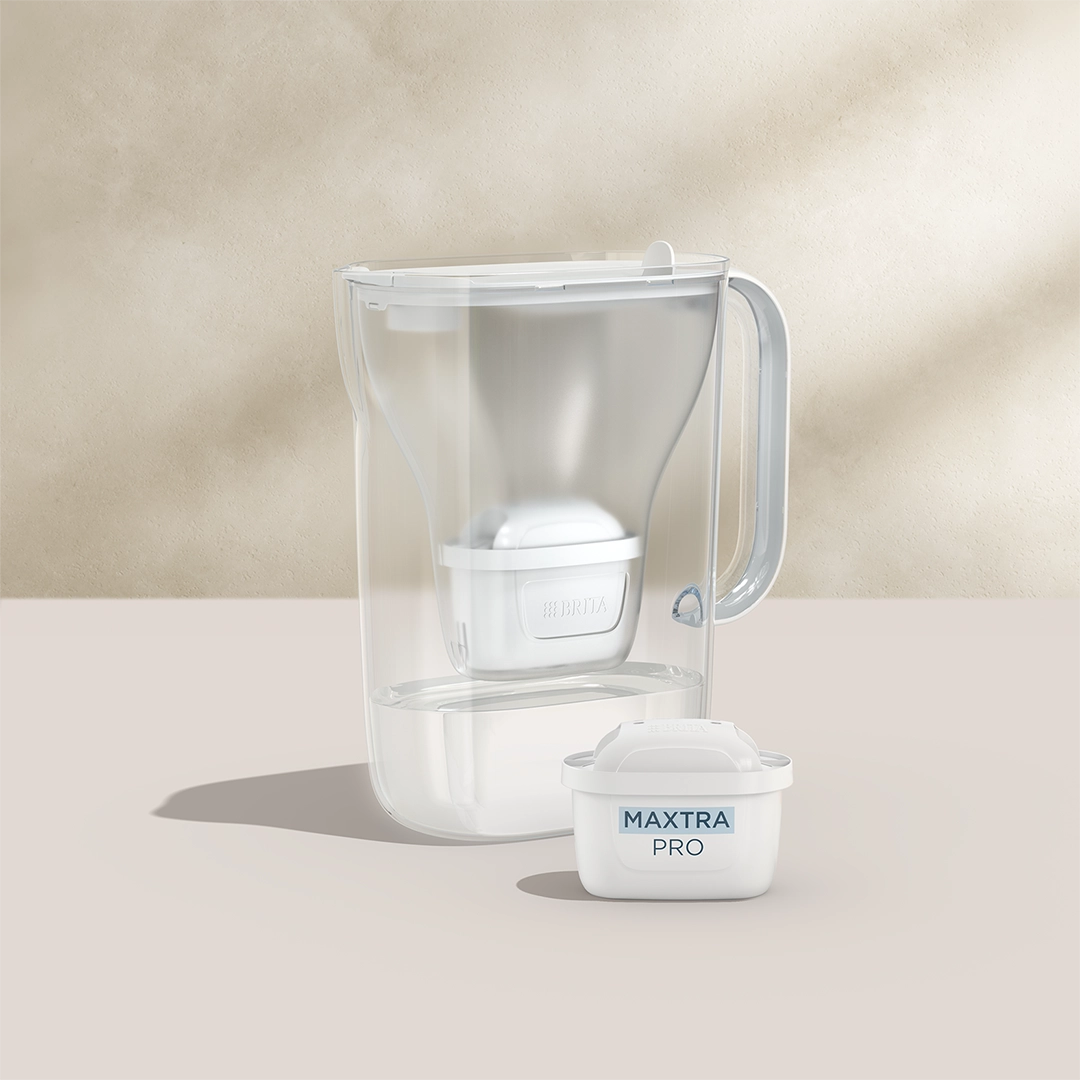 BRITA Style Essential in white with a MAXTRA PRO filter cartridge on a beige background.